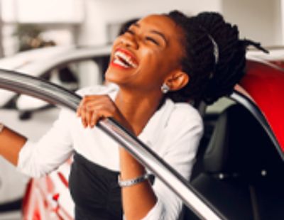 Mulher rindo fora de um carro