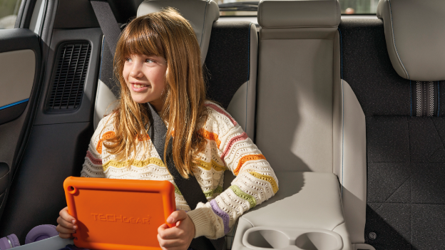 Child with tablet in car